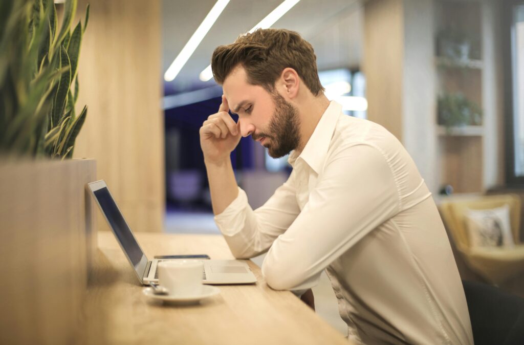 Photo by Andrea Piacquadio: https://www.pexels.com/photo/man-with-hand-on-temple-looking-at-laptop-842554/